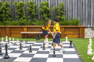 students playing chess at multipurpose courts